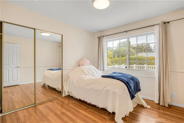 a bedroom with a bed and a large window