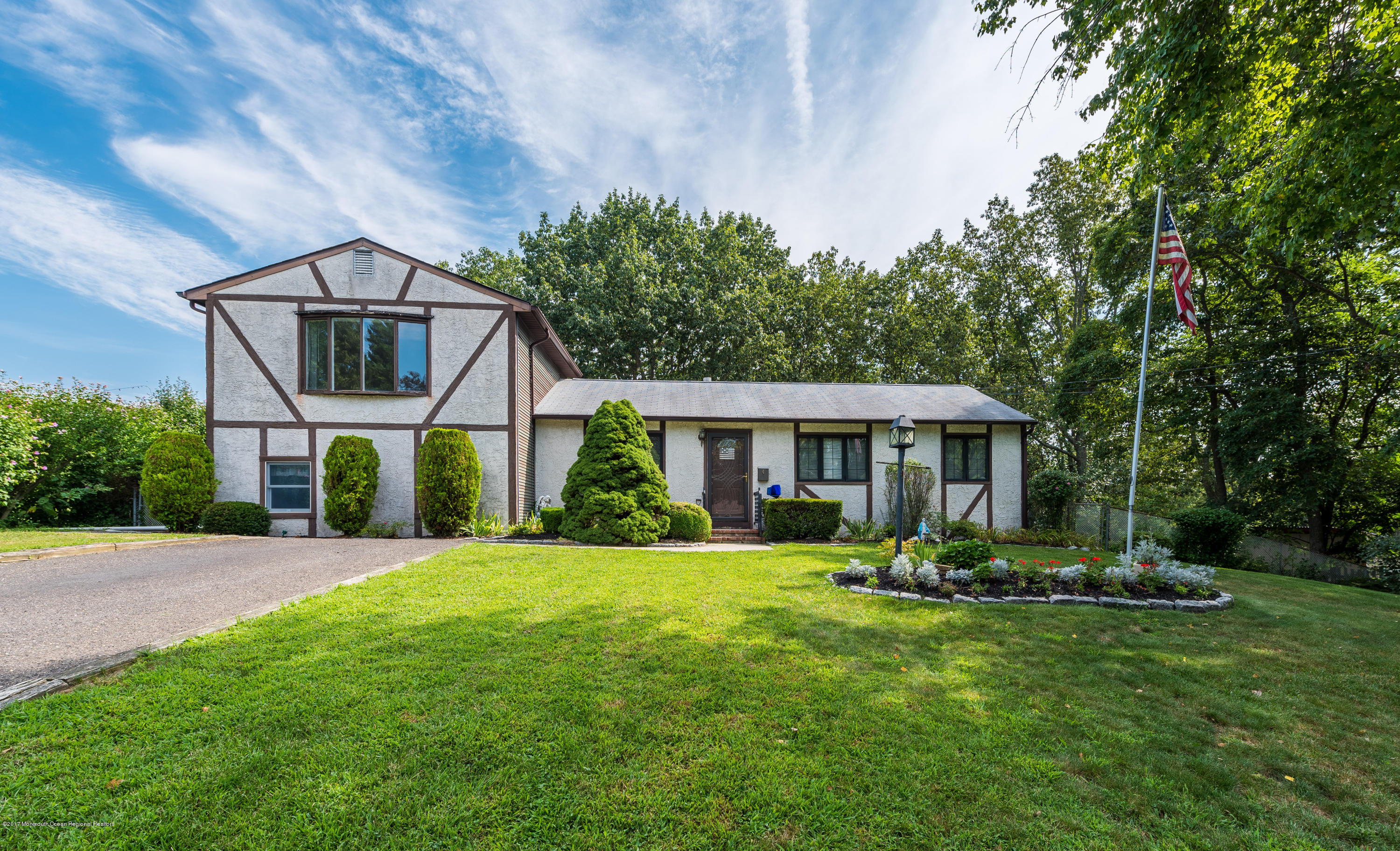 4 Hemlock Road Howell, NJ 07731 - Photo 1 of 15 a front view of a house with a yard table and chairs