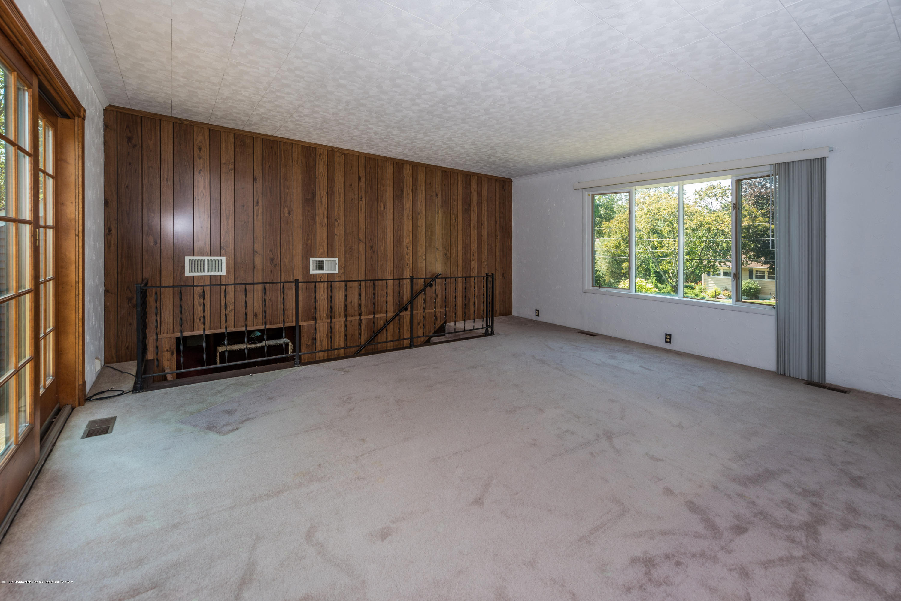 4 Hemlock Road Howell, NJ 07731 - Photo 2 of 15 a view of an empty room with wooden walls and windows