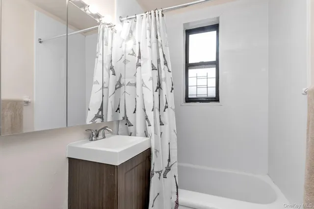 a bathroom with a sink a mirror and a shower