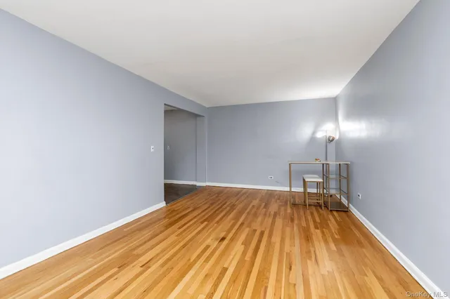 a view of a room with wooden floor and bench