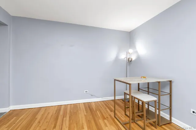 a view of a room with a table and chairs