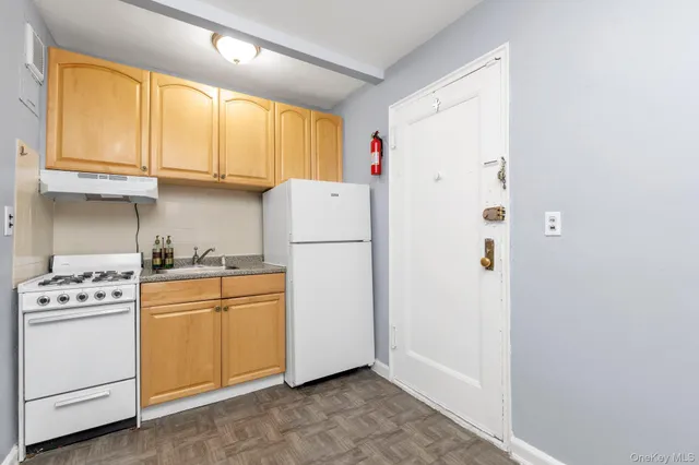 a kitchen with a refrigerator a stove a microwave and cabinets