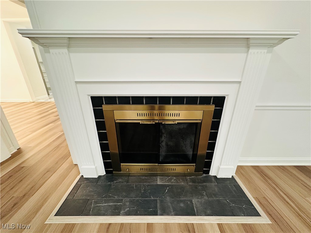568 North Road Southeast Warren, OH 44484 - Photo 23 of 49 Detailed view of luxury vinyl floors and a tile fireplace