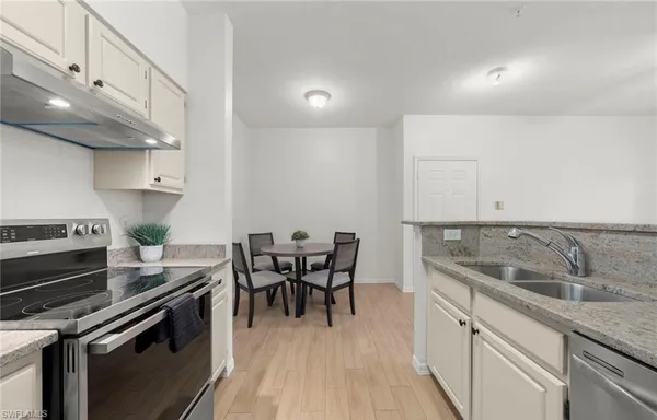 a view of swimming pool with lawn chairs and plants