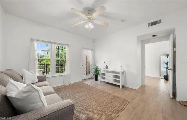 a view of hall way with furniture and floor to ceiling windows