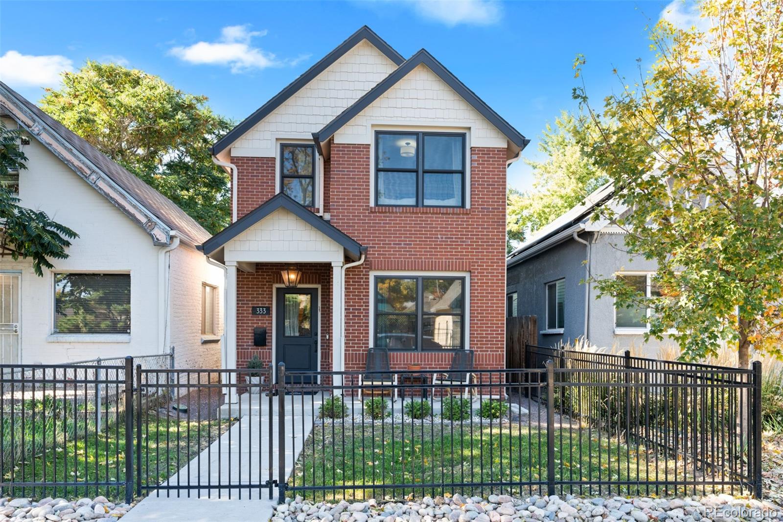 a front view of a house with a garden and plants