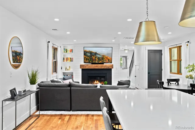 a living room with furniture a fireplace and a flat screen tv