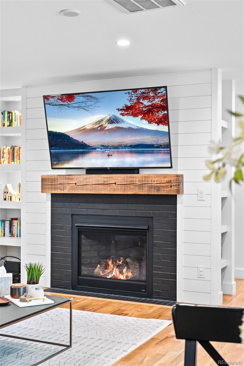 333 Delaware Street Denver, CO 80223 - Photo 13 of 44 a living room with furniture a fireplace and a wall painting