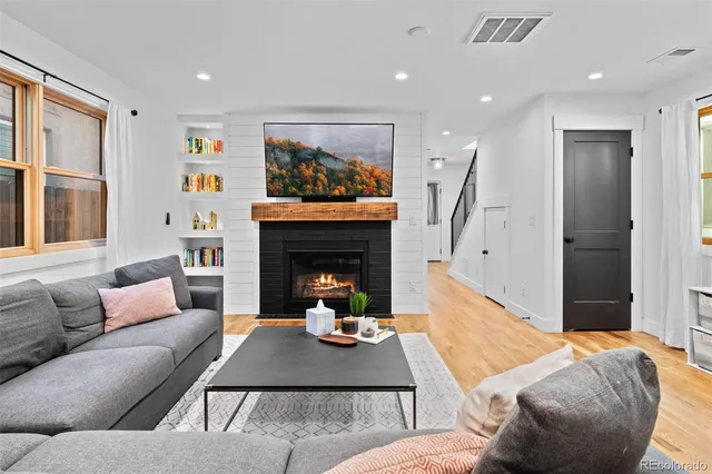 a living room with furniture and a fireplace