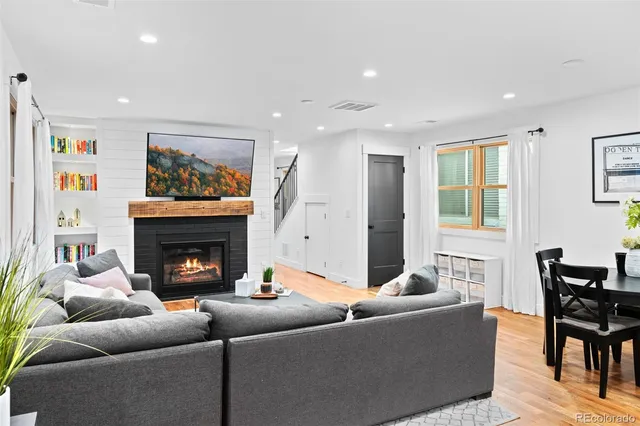 a living room with furniture and a fireplace