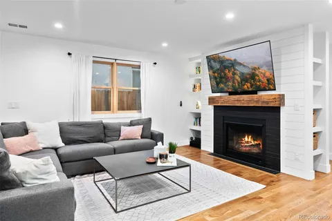 a living room with furniture and a fireplace
