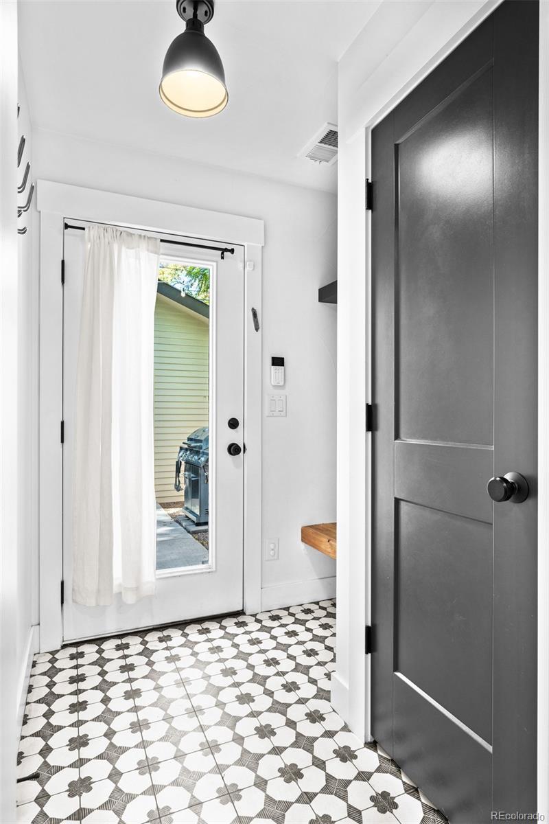333 Delaware Street Denver, CO 80223 - Photo 20 of 44 a bathroom with a glass shower door
