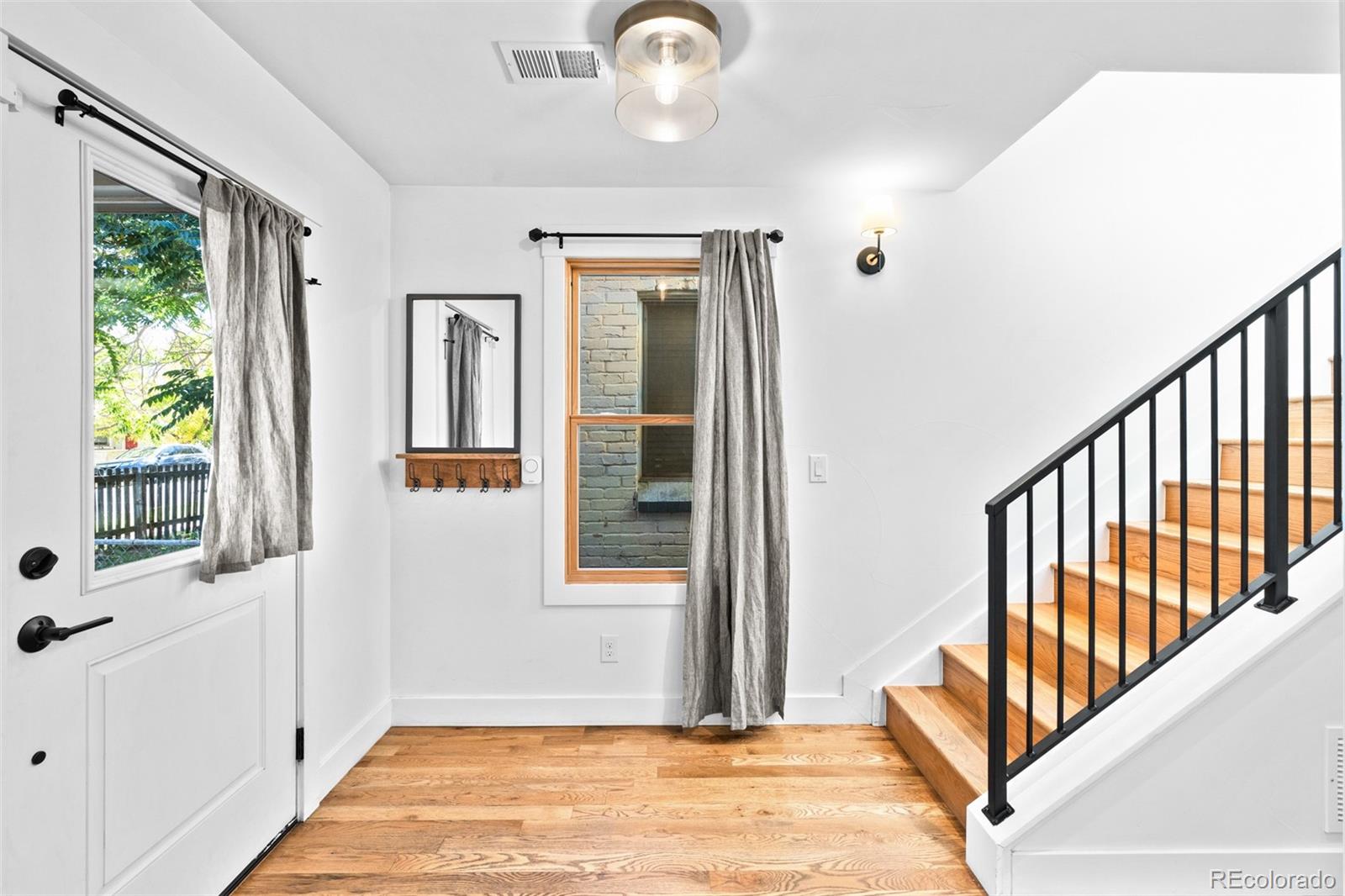333 Delaware Street Denver, CO 80223 - Photo 22 of 44 a view of an entryway with wooden floor and windows