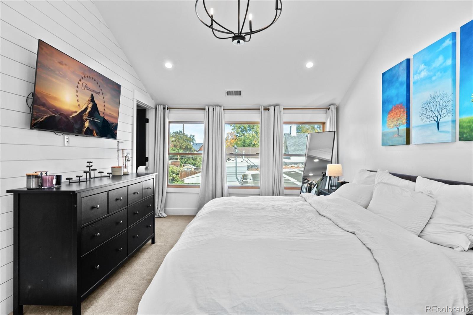 333 Delaware Street Denver, CO 80223 - Photo 25 of 44 a large bedroom with a large bed and flat tv screen