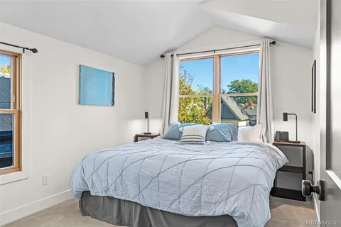 a bedroom with a bed and window