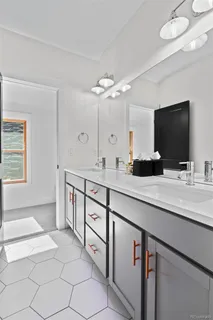 a bathroom with a double vanity sink and a mirror