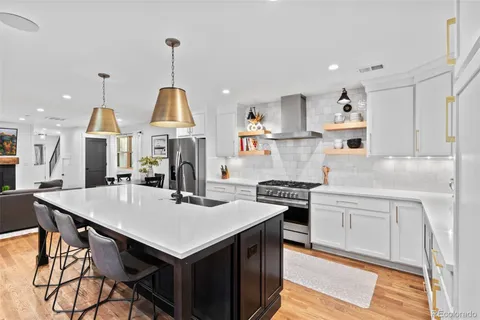 a kitchen that has a table and chairs in it