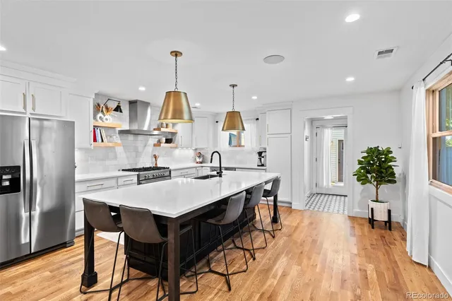 a large kitchen with a table and chairs