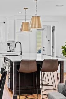 a kitchen with a table chairs sink and cabinets