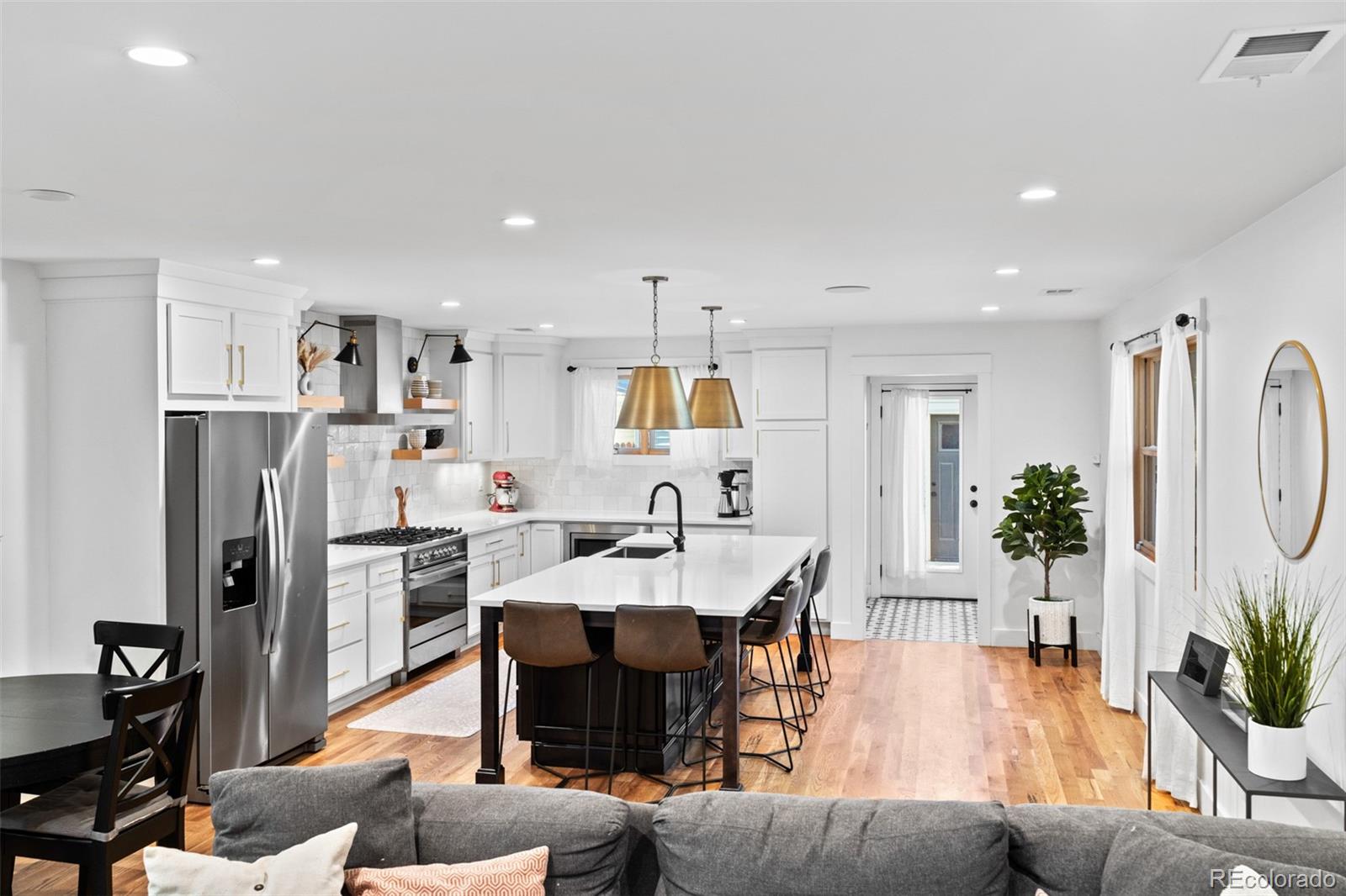 333 Delaware Street Denver, CO 80223 - Photo 10 of 44 a living room with stainless steel appliances kitchen island granite countertop furniture and a dining table