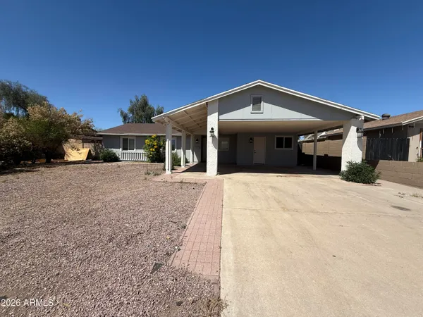 a view of a house with a backyard