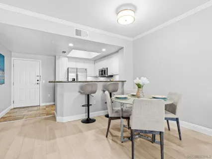 a kitchen with a dining table chairs and view of kitchen