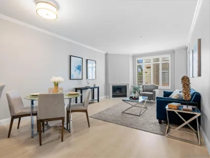 a living room with furniture a table and a window