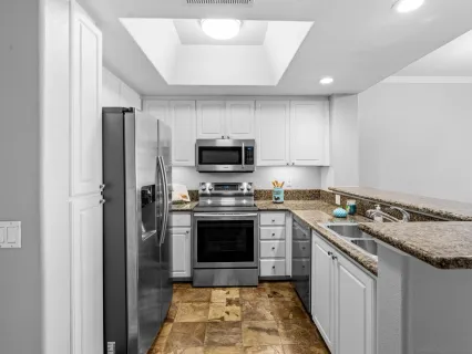 a kitchen with a sink stove and refrigerator