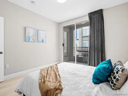 a bedroom with a bed and a painting on the wall