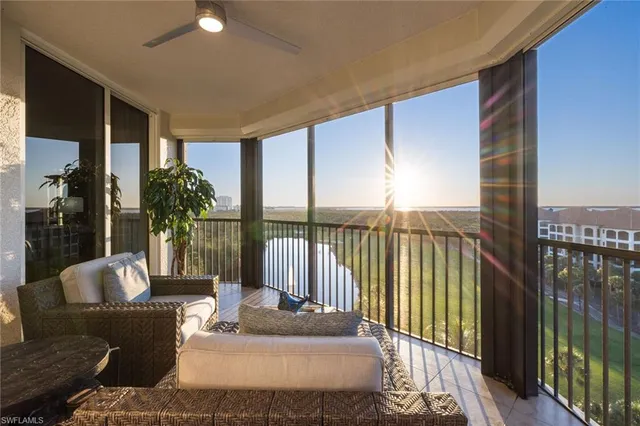 a living room with furniture and a floor to ceiling window
