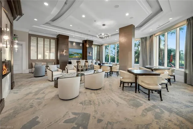 a living room with furniture and large windows