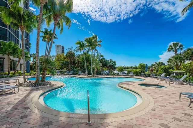 a view of a swimming pool with a yard