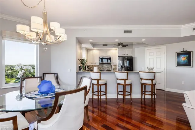 a view of a dining room with furniture wooden floor and chandelier