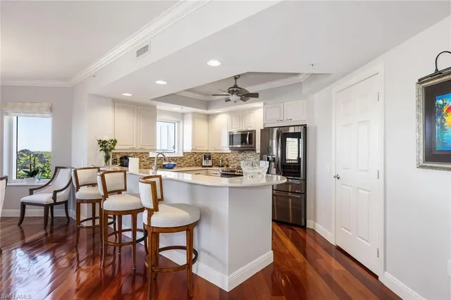 a large kitchen with a table and chairs