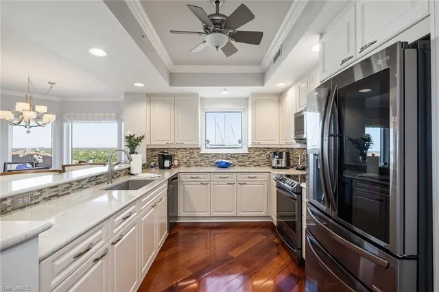 a kitchen with a sink stainless steel appliances and cabinets