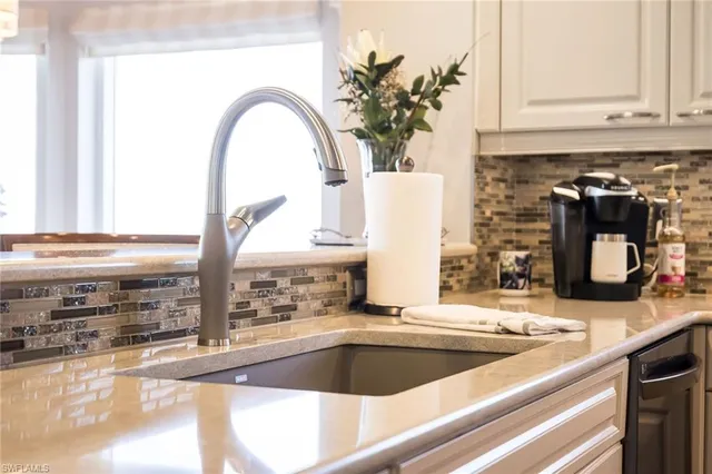 a kitchen with a sink and a large window