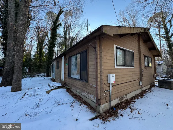 a view of a house with a yard covered in snow