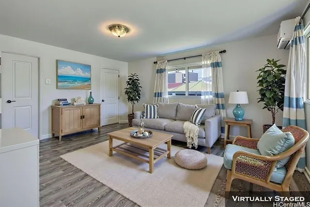 a living room with furniture and a chandelier