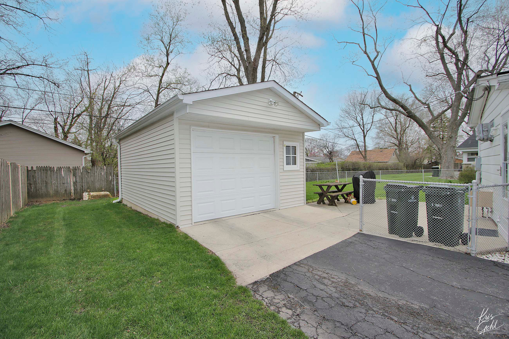 514 Warren Road Glenview, IL 60025 - Photo 20 of 21 a view of a white house next to a yard and a large tree