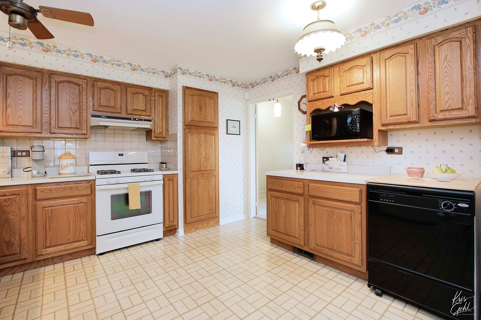 514 Warren Road Glenview, IL 60025 - Photo 5 of 21 a kitchen with stainless steel appliances granite countertop a stove top oven a sink dishwasher and white cabinets with wooden floor