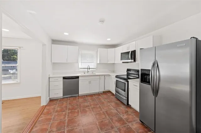 a kitchen with a refrigerator sink and microwave