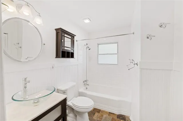 a bathroom with a toilet a sink and bathtub