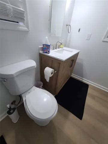 a bathroom with a sink mirror vanity and toilet
