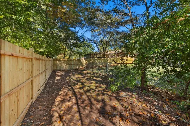 a view of a yard with large trees