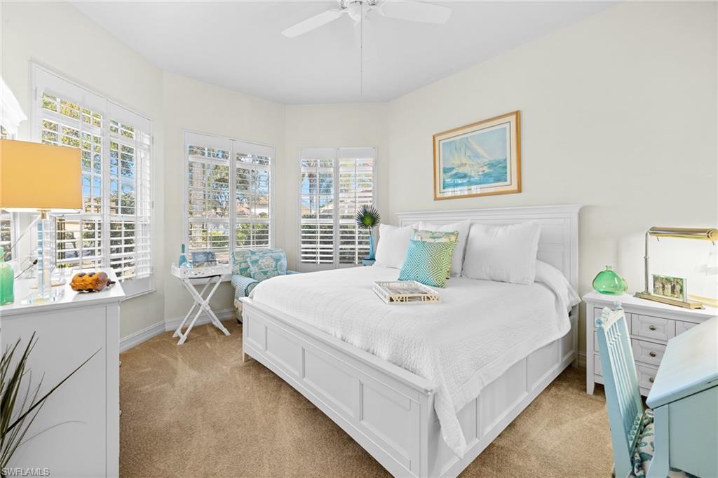 6737 Bent Grass Drive Naples, FL 34113 - Photo 12 of 31 a bed room with a bed and a table