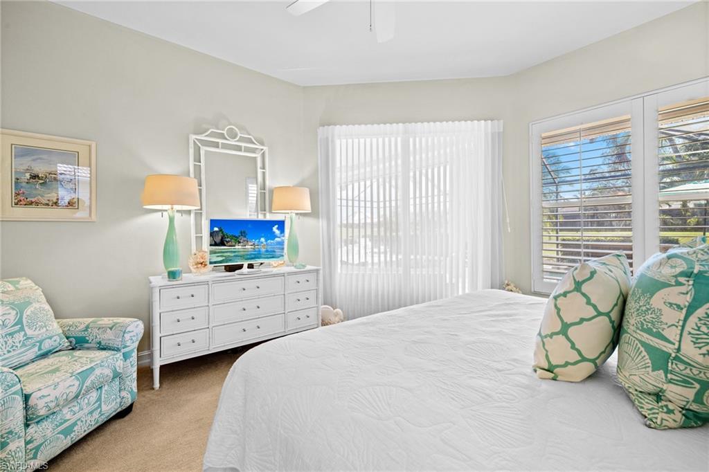 6737 Bent Grass Drive Naples, FL 34113 - Photo 13 of 31 a bedroom with a bed and a window