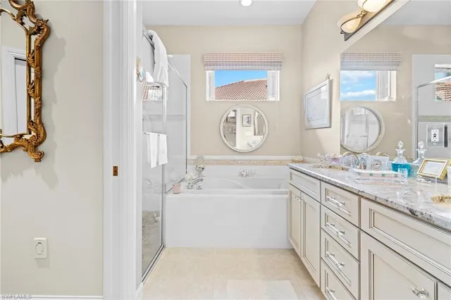 a bathroom with a tub sink and mirror