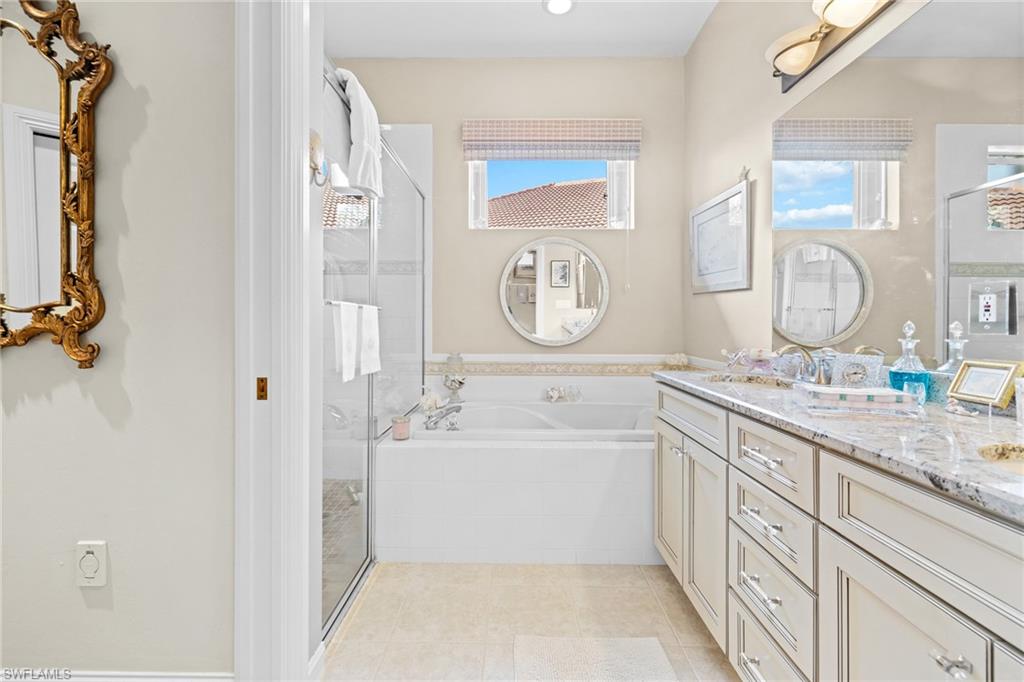 6737 Bent Grass Drive Naples, FL 34113 - Photo 14 of 31 a bathroom with a tub sink and mirror