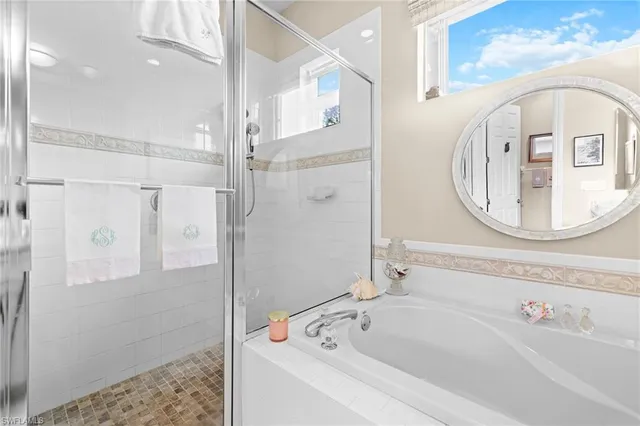 a bathroom with a bathtub and a shower